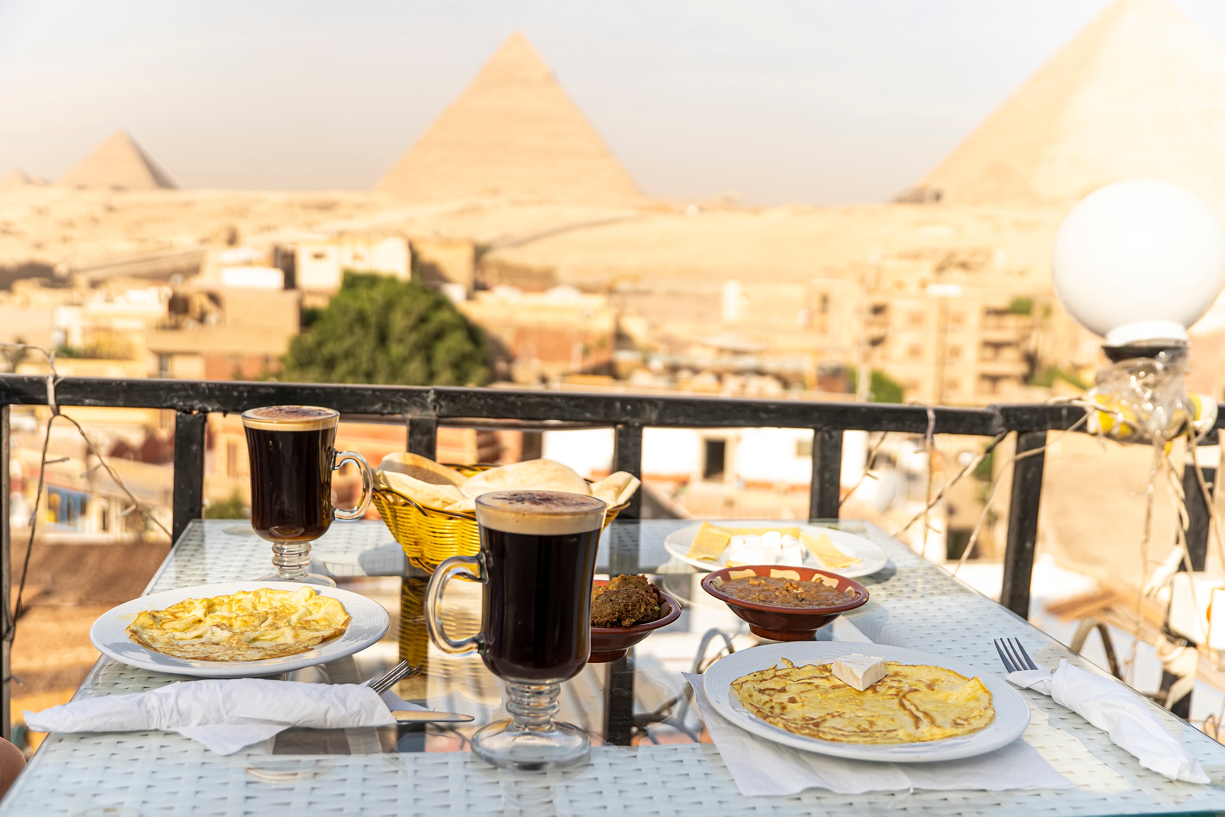 A table in an outdoor restaurant with a fantastically beautiful view of the great pyramids of Giza. Cairo. Egypt.